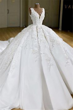 a white wedding dress on display in a room