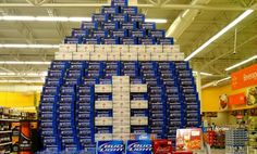 a large pile of beer stacked on top of each other in a grocery store aisle