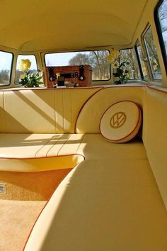 the interior of an old car with sunroofing and decorative cushions on it