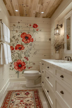 a bathroom with a floral wallpaper and rug on the floor next to the toilet