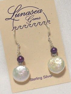 BEADED DANGLE EARRINGS OF FRESH WATER PEARLS by LUNASEA TREASURES.  DESIGN INCLUDES A 12mm COIN SHAPED WHITE PEARL TOPPED WITH A 5mm POTATO SHAPED PURPLE PEARL.  THEY ARE ACCENTED WITH STERLING SILVER RONDELLES.  EARRINGS DANGLE 7/8" FROM FRENCH EAR WIRES.   ALL FINDINGS ARE STERLING SILVER.  SAFETY BACKS ARE INCLUDED.  ANOTHER PRETTY DESIGN FROM NEW ENGLAND. Froo www.froo.com | Froo Cross Sell, Free Cross Sell, Cross promote, eBay Marketing, eBay listing Apps, eBay Apps, eBay Application Flat Pearl Earrings, Simple Bead Earrings, Simple Pearl Earrings, Pearl Earrings Designs, Coin Pearl Earrings, Pearl Earrings Handmade, Artisan Jewelry Earrings, Beaded Jewelry Necklaces, Handmade Jewelry Earrings