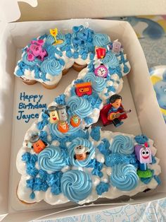 a birthday cake in the shape of number five with blue frosting and thomas the train decorations