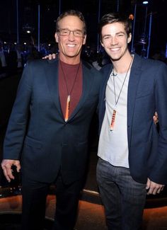 two men standing next to each other smiling