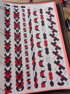 an open notebook with red and black designs on it