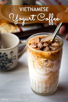 vietnamese yogurt coffee in a glass with ice and toppings on the side