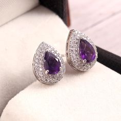 "This Earrings features a beautiful Amethyst gemstone set in a customized sterling Silver A lovely Earring to your jewelry collection ! Item Description ! => Gemstone Type - Amethyst => Gemstone Size - 6 x 9 mm => Gemstone Cut - Faceted Pear => Metal Type (Main Photo) - 925 Sterling Silver =>Gemstone Quality: AAA+ =>Secondary Stone - cubic Zircon(Small white Stone) ? Shipping information : ? Tracking number ? ? Expedited / Express shipping - check our \"shipping upgrades\" when Pear Earrings, Plus Size Rings, Minimalist Earrings Studs, Choker Pendant, Minimalist Studs, Blue Topaz Earrings, Earrings Dainty, Studs Earrings, Art Deco Earrings