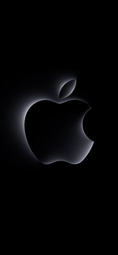 an apple logo on a black background with the light reflecting off it's side