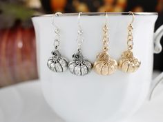 Add a festive touch to your jewelry collection with these delightful pumpkin earrings!  Made with .925 sterling silver and hung from .925 sterling silver ear wires, these pumpkin earrings will add a touch of whimsy to your fall outfits or surprise a friend with this charming gift. Whether you wear them to fall festivals, Thanksgiving gatherings, or Halloween parties, these pumpkin earrings are sure to grab attention. Embrace the spirit of the season and celebrate the magic of autumn with these d Elegant Fall Jewelry Gift, Elegant Fall Jewelry For Gifts, Fall Season Gift Dangle Earrings, Halloween Silver Drop Earrings, Halloween Sterling Silver Dangle Earrings, Silver Drop Earrings For Halloween, Silver Earrings For Halloween Gift, Thanksgiving Earrings, Pumpkin Jewelry