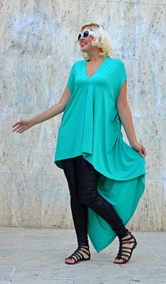 Extravagant teal top made of the finest viscose, very playful and loose, perfect for summer. The bright teal and the long tail will for sure steal the spotlight on the urban scene in this season. Material: 95% Viscose, 5% Elastane Care instructions: Wash at 30 degrees The model in the picture is size S. Can be made in ALL SIZES. If you have any other specific requirements, do not hesitate to contact me! I DO NOT CHARGE EXTRA MONEY for custom made items. All you need to do is send me your measure Drapey Asymmetrical Summer Tops, Summer Asymmetrical Viscose Top, Asymmetrical Viscose Top For Summer, Green Flowy V-neck Top, Green Viscose Short Sleeve Tops, Summer Green Lagenlook Blouse, Green Lagenlook Summer Tops, Green Blouse With Asymmetrical Hem For Summer, Green Asymmetrical Stretch Top