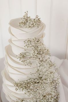 a white wedding cake with flowers on top