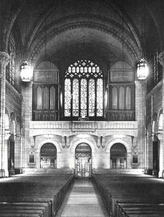 the interior of an old church with pews and stained glass windows