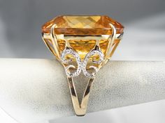 This citrine cocktail ring is sure to turn heads! This whopping gem sparkles with sunshine hues and undertones of honey, perfectly paired with warm yellow gold. Swirling diamond accents add even more glamour to this statement ring! Metal: 14K Yellow and White Gold Gem: Citrine Gem Measurements: 22.3 x 26.2 mm, Oval Accents: 8 Diamonds totaling .04 Carats Ring Size: 6.75 Marks: "14K 585" Stamped on the inside band Gold Cocktail Ring, Pocket Watch Chain, Warm Yellow, Gold Cocktail, Watch Chain, Color Analysis, Diamond Gold, Ring Metal, Cocktail Ring