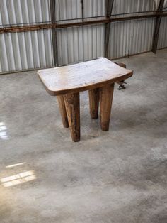 a wooden table sitting inside of a building