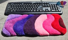 a computer keyboard sitting on top of a pile of towels