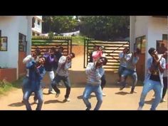 a group of young men dancing in front of a building