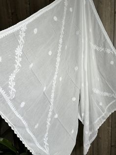 Classic white Chikankari pure cotton dupatta with hand embroidery and crochet lace. Luxury Chanderi Fabric With Chikankari Embroidery, Luxury Chikankari Embroidery Maxi Length Dupatta, Luxury Festive Chikankari Embroidery Dupatta, Off White Mulmul Dupatta With Embroidered Border, White Cotton Dupatta With Cutdana, Wedding Cotton Dupatta With Cutwork, Wedding Cotton Cutwork Dupatta, Cotton Cutwork Dupatta, Bohemian Cotton Dupatta For Wedding