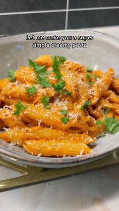 a pasta dish with cheese and parsley on top