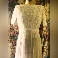 I Love It When I Come Across These Antique Cotton Dresses In Great Condition. This One Is Absolutely Beautiful Very Intricate Lace And Rodri At The Bottom. The Bottoms Is Also Beautiful Drawn Lace And Embroidery Work. The Sleeves Are Also Pleated And Finished With Lace. The Dress Is On A Size 10 Mannequin And I Could Not Close The Back So It Is Probably About A Size 6 -The Antique Sizes Are All Just Approximate.The Sleeve Length Is 10 Inches.The Waist Side To Side, Lying Flat, Is Only 10 Inches Feminine Daywear Dresses With Lace Trim, White Maxi Dress With Fitted Bodice For Daywear, Fitted Maxi Dress With Lace Patchwork And Short Sleeves, Fitted Short Sleeve Maxi Dress With Lace Patchwork, Short Sleeve Dresses With Lace Patchwork For Daywear, Short Sleeve Dresses With Lace Patchwork For Garden Party, Garden Party Dress With Lace Patchwork And Short Sleeves, White Fitted Vintage Dress, Feminine Lace Work Short Sleeve Dress