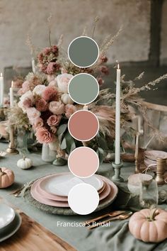 the table is set with plates, candles and flowers in shades of gray, pink, green