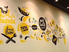 the wall is decorated with yellow and black lettering, which are all on it's sides