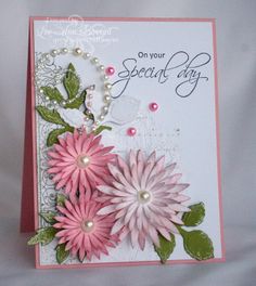 a card with pink flowers and pearls on it