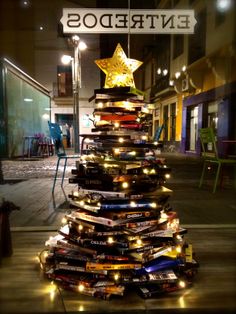 a christmas tree made out of books on the street