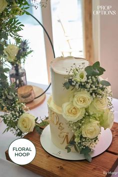 a white wedding cake with flowers on top