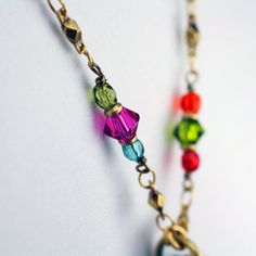 This heart hoop necklace embellished with a wide variety of multi-color Swarovski crystal and glass beads set into rainbow enamel placed on a chain beaded with Swarovski crystals and glass beads is inspired by it's own abstract and bright shape. This handmade piece is a one of a kind, fashionable statement necklace that will be perfect for any spring outfit or as a lovely gift for valentine's day. Pendant Length: 1.75 inches Pendant Width: 1.5 inches Necklace Length: 20.25 inches Additional Exte Multicolor Round Beads Metal Jewelry, Multicolor Dangle Jewelry With Lobster Clasp, Bohemian Crystal Jewelry With Faceted Beads, Multicolor Faceted Beads Dangle Necklaces, Multicolor Dangle Necklaces With Faceted Beads, Crystal Beaded Chain Necklace For Gift, Colorful Metal Necklace As A Gift, Bohemian Heart-shaped Jewelry With Faceted Beads, Colorful Metal Necklaces For Gifts