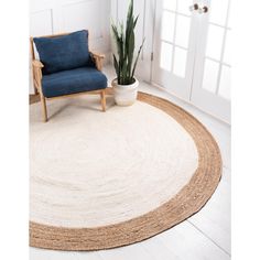 a large round rug with a blue chair in the corner and a potted plant next to it