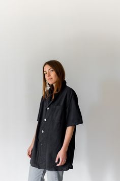 "Black short sleeve over shirt with one front chest pocket and four white buttons. Thicker over shirt material. Maker: Military | Made in USA in the 60s. Garment Dyed in Los Angeles in 2019. Material: 100% Cotton 6 oz. Condition: Excellent. may have tiny pin holes. -X SMALL- Shoulders: 17\" | Chest: 18\" | Length: 28\" | Sleeve: 10\" -SMALL- Shoulders: 17\" | Chest: 20\" | Length: 28\" | Sleeve: 10.5\" -MEDIUM- Shoulders: 18\" | Chest: 21-22\" | Length: 30\" | Sleeve: 11\" -LARGE- Shoulders: 20\ Dark Green Shirt, Small Shoulders, Blue Button Up Shirt, Army Pants, Work Coat, Army Jacket, Half Zip Sweaters, Work Shirt, Blue Denim Shorts