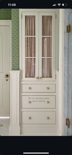 a white cabinet sitting in the corner of a room