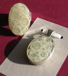 a pair of earrings sitting on top of a mat