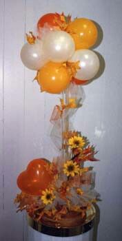 an arrangement of balloons and flowers in a vase