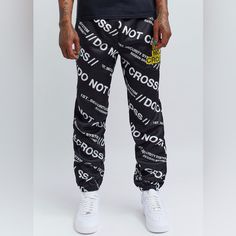 “Do Not Cross Me” Joggers Athleisure Streetwear Pants With Logo Print, Casual Black Pants With Logo Print, Sporty Black Pants With Logo Print, Black Joggers With Graphic Print For Streetwear, Black Graphic Print Joggers For Streetwear, Spring Streetwear Bottoms With Logo Print, Urban Graphic Print Bottoms For Streetwear, Sporty Logo Print Bottoms For Spring, Urban Black Joggers For Spring