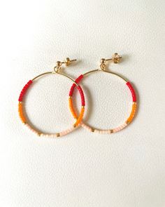 "The Sunny Hoops- Delicate hoops, from 14kt gold filled wire, lined with high quality Japanese glass Miyuki beads.  Colors on the Sunny hoops include: bright red, tangerine orange and peach. All beads are added one by one, handmade, in the set pattern as shown.  Hoops size is 1.25\" in diameter. If you would like a larger pair, let me know before hand and I'd be happy to meet your requests. Made with a ball and stud push back earring closure as pictured.  This listing is for one pair of earring hoops.  QUALITY MATERIALS: Every item in this shop is delicately handmade, making each piece unique and one of a kind. I use high quality 14kt gold fill or sterling silver material (unless stated in the listing) for jewelry that should last years if handled with care. Gold filled jewelry outlasts go Colorful Beads Small Hoop Jewelry, Colorful Beads Small Hoop Earrings, Seed Bead Hoop Earrings, Summer Colorful Beaded Hoop Earrings, Everyday Colorful Bead Hoop Earrings, Gold Hoop Earrings With Colorful Beads For Beach, Dainty Hoop Earrings, Black Pearl Necklace, Tiny Hoop Earrings