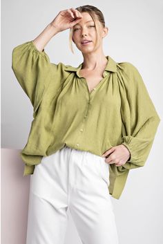 Solid long sleeve blouse top featuring a button down front, elastic cuffs for a bubble sleeve effect, two side slits, a collared neckline and is pinched for extra detail. beautiful avocado color Elevate your wardrobe with this playful blouse. With a button down front and elastic cuffs that create a bubbly sleeve effect, it's unique and trendy. Featuring subtle details like side slits and a collared neckline, this blouse adds flair to any outfit. Plus, the beautiful avocado color is sure to turn Avocado Color, Bubble Sleeve, Confident Woman, Women Supporting Women, Spring Collection, Blouse Top, Warm Weather, Avocado, Sleeve Blouse