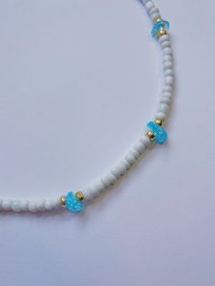 Dainty handmade beaded choker necklace with gemstone and bead pattern. This necklace featuring sparkling gemstones adds a pop of color to any outfit and is perfect to wear to the beach! Grab multiple colors to match your bathing suits and beach outfits. Necklace features: 13.5 inches in length with a 2 inch extender chain White seed beads with galvanized gold seed beads surrounding each gemstone bead Colors: Amazonite: matte blue/green Amethyst: dark purple Aquamarine: light blue Aventurine: lig Seed Bead Gemstone Necklace, Green Amazonite, Blue Aventurine, Blue Sapphire Necklace, Light Pink Rose, Bead Choker, Beach Outfits, Bead Pattern, Beaded Choker Necklace