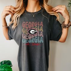 Also available as a sweater. See below. Get ready to cheer on your Georgia Bulldogs in style with our GA Go Dawgs T-Shirt! This graphic tee is perfect for game day and showing off your team spirit. Made with high-quality materials, you'll stay comfortable and stylish all day long. Go Dawgs! Georgia Bulldog Glitter Shirt, Collegiate Graphic Print T-shirt For Game Day, Team-colored Graphic T-shirt For Game Day, Team-colored Graphic Print T-shirt For Game Day, Tri-blend Fan Apparel T-shirt For Game Day, Sports Fan Graphic T-shirt For College, Game Day Graphic Tee With Text Print, Graphic Tee T-shirt For Game Day With Text Print, Graphic Tee With Text Print For Game Day