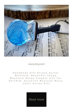 a blue glass object sitting on top of sheet music