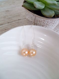 These very pretty earrings are perfect all year around and will make a beautiful addition to any jewellery collection. The beautiful Pink colour of the pearl means they are appropriate for all occasions. The earrings are made of lovely peach pink fresh water pearls on sterling silver hooks. All jewellery is made in my Secret Garden Studio. Elegant Orange Pearl Drop Jewelry, Elegant Orange Earrings For Gift, Elegant Orange Sterling Silver Earrings, Elegant Apricot Dangle Earrings, Elegant Orange Nickel-free Earrings, Elegant Apricot Dangle Jewelry, Peach Pearl Drop Jewelry As Gift, Peach Pearl Drop Jewelry For Gift, Elegant Nickel-free Orange Earrings