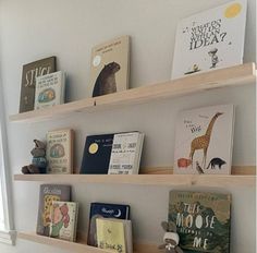 three wooden shelves with books on them