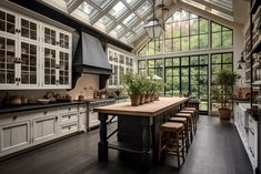 a large kitchen with an island in the middle and lots of windows on the wall