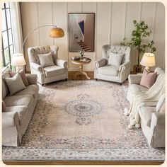 a living room with couches, chairs and a rug on the floor in front of a window