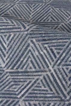 a close up view of a blue and white rug