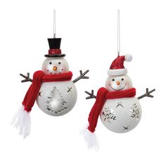 two snowman ornaments hanging from strings