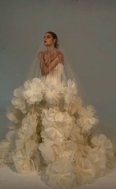 a woman in a wedding dress with flowers on it