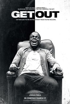 a black and white photo of a man sitting in a chair with his mouth open