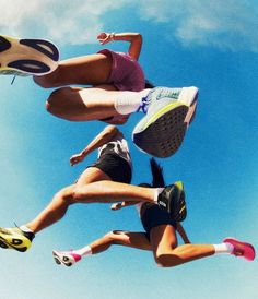 two women are jumping in the air with their shoes on