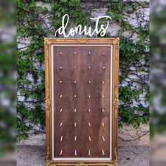 a wooden sign that says donuts on it