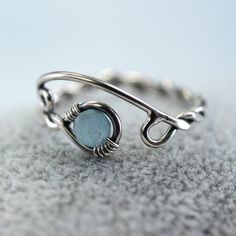 A silver and aquamarine ring with a twist and open spiral design. It's adjustable and perfect as a gift if you're not quite sure of the size you need. The shank is twisted from one wire and in the loop at the end is nestled a round faceted aquamarine bead. This version is milky which highlights the colour wonderfully and reminds me of frozen lakes and ice skating. Versions with a clear aquamarine and with moss aquamarine are also available in my shop. The opposite end from the gem is shaped into Viking Jewellery, Moss Aquamarine, Viking Ring, Braided Ring, Celtic Rings, Aquamarine Beads, Aquamarine Ring, March Birthstone, Spiral Design